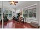 Home office featuring wood floors and multiple windows for natural light at 15934 Sorawater Dr, Lithia, FL 33547
