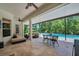 Relaxing covered patio with comfortable seating and views of the private pool and landscaping at 15934 Sorawater Dr, Lithia, FL 33547