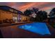 Backyard view of a sparkling pool and patio area perfect for entertaining guests at 15934 Sorawater Dr, Lithia, FL 33547