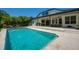 Stunning pool with travertine tile, surrounded by a covered patio with ample seating for entertaining at 15934 Sorawater Dr, Lithia, FL 33547