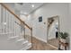 Bright foyer with hardwood flooring, staircase with white railings, and a large mirror at 15934 Sorawater Dr, Lithia, FL 33547