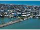 Scenic aerial view of canal-front homes, a connecting causeway, and a vibrant coastal community at 16047 Redington Dr, Redington Beach, FL 33708