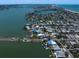 Panoramic aerial view of a coastal community with homes nestled around waterways and a sandy beach in the distance at 16047 Redington Dr, Redington Beach, FL 33708