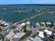 Stunning aerial view showcasing homes along the water with boat access, in a peaceful coastal community at 16047 Redington Dr, Redington Beach, FL 33708