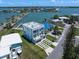 Aerial view of modern home on a large lot, complete with a dock and boat lift on the waterfront at 16047 Redington Dr, Redington Beach, FL 33708