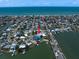 Aerial shot of the home in a scenic coastal neighborhood with ocean views at 16047 Redington Dr, Redington Beach, FL 33708