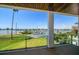 Waterfront balcony with lush green yard, dock, and beautiful views of the serene water at 16047 Redington Dr, Redington Beach, FL 33708
