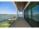 Spacious balcony with waterfront views, glass railing, and sliding glass door access at 16047 Redington Dr, Redington Beach, FL 33708