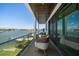 Waterfront balcony with cozy seating offering breathtaking views of the water and neighborhood at 16047 Redington Dr, Redington Beach, FL 33708