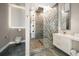 Modern bathroom featuring an enclosed shower, a toilet, and a single sink at 16047 Redington Dr, Redington Beach, FL 33708