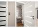 Bathroom with decorative door open showing the sink, toilet and marble floors at 16047 Redington Dr, Redington Beach, FL 33708
