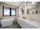 Modern bathroom features double vanity, a soaking tub, and marble flooring at 16047 Redington Dr, Redington Beach, FL 33708