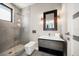 Modern bathroom features a glass shower with a rainfall shower head, updated lighting, and vanity at 16047 Redington Dr, Redington Beach, FL 33708