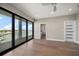 This bedroom features hardwood floors, recessed lighting, and sliding glass doors to outdoor balcony at 16047 Redington Dr, Redington Beach, FL 33708