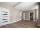 Spacious bedroom featuring wood floors, modern doors, and ensuite bathroom access at 16047 Redington Dr, Redington Beach, FL 33708