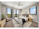 Stylish bedroom with large windows, modern furnishings, and a comfortable queen-size bed at 16047 Redington Dr, Redington Beach, FL 33708