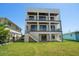 This three story home features modern architecture with a beautiful yard at 16047 Redington Dr, Redington Beach, FL 33708