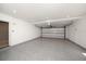 Spacious two car garage with an epoxy floor, white walls, and a roll-up door at 16047 Redington Dr, Redington Beach, FL 33708