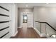 Hallway featuring wood floors, modern doors, and a glimpse of the waterfront view through an open door at 16047 Redington Dr, Redington Beach, FL 33708
