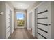 Bright hallway with wood floors, modern doors, and a window with a serene view at 16047 Redington Dr, Redington Beach, FL 33708
