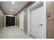 Interior hallway with neutral walls and modern doors, leading to various rooms within the home at 16047 Redington Dr, Redington Beach, FL 33708