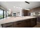 Open kitchen overlooking living area with island seating and modern appliances at 16047 Redington Dr, Redington Beach, FL 33708