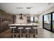 Modern kitchen island with seating, pendant lighting, and stainless steel appliances at 16047 Redington Dr, Redington Beach, FL 33708