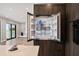 A modern refrigerator with double doors sits next to the open-concept kitchen and living area at 16047 Redington Dr, Redington Beach, FL 33708