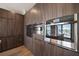 Modern kitchen features wood cabinetry, stainless steel appliances and a window with an island view at 16047 Redington Dr, Redington Beach, FL 33708