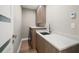 Well-lit laundry room with modern cabinets, white countertops, and a sink at 16047 Redington Dr, Redington Beach, FL 33708