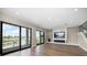 Bright living room featuring a modern fireplace, expansive windows, and a waterfront view at 16047 Redington Dr, Redington Beach, FL 33708