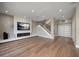 Bright living room with hardwood floors, recessed lighting, and modern fireplace at 16047 Redington Dr, Redington Beach, FL 33708