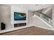 Contemporary living room boasting a unique fireplace and modern staircase at 16047 Redington Dr, Redington Beach, FL 33708