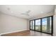 Open bedroom featuring hardwood floors, recessed lighting, and sliding glass doors to outdoor balcony at 16047 Redington Dr, Redington Beach, FL 33708