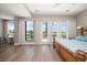 Bright main bedroom boasts a bamboo bed frame, light hardwood floors, and views of the community at 16047 Redington Dr, Redington Beach, FL 33708