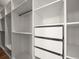 White closet with open shelving, drawers and metal hanging rack at 16047 Redington Dr, Redington Beach, FL 33708