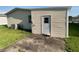 Back of home showing a grey exterior door and concrete pad, adding functionality to the property at 1710 7Th Sw St # 85, Ruskin, FL 33570