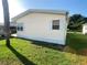 Home featuring well-maintained lawn, showcasing the property's exterior at 1710 7Th Sw St # 85, Ruskin, FL 33570