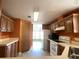 Traditional-style kitchen with white appliances, wood cabinetry, and plenty of counter space for meal preparation at 1710 7Th Sw St # 85, Ruskin, FL 33570
