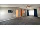 Comfortable living room featuring gray carpet, a ceiling fan, and a glimpse into the adjacent kitchen at 1710 7Th Sw St # 85, Ruskin, FL 33570