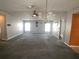 Inviting living room with gray carpeting, ceiling fan, and decorative chandelier, creating a cozy atmosphere at 1710 7Th Sw St # 85, Ruskin, FL 33570