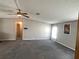 Bright living room with a ceiling fan, gray carpet, and an open doorway leading to other rooms at 1710 7Th Sw St # 85, Ruskin, FL 33570