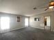 Spacious living room with gray carpet, ceiling fan, and natural light, perfect for relaxing and entertaining at 1710 7Th Sw St # 85, Ruskin, FL 33570