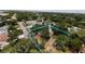 An aerial shot emphasizing the property's expansive lot size and mature trees that offer privacy and shade at 2033 Aaron Pl, Clearwater, FL 33760