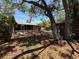 Spacious backyard featuring screened porch, landscaping, and mature trees at 2033 Aaron Pl, Clearwater, FL 33760
