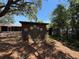 Backyard shed featuring colorful flower paintings and landscaping at 2033 Aaron Pl, Clearwater, FL 33760