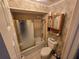 Bathroom with a tub, shower, toilet, and a wood cabinet over toilet at 2033 Aaron Pl, Clearwater, FL 33760