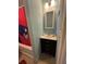 Bathroom includes a vanity with sink and a shower/tub combo with a sports themed curtain at 2033 Aaron Pl, Clearwater, FL 33760