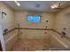 Spacious tiled shower equipped with multiple shower heads and built in benches at 2033 Aaron Pl, Clearwater, FL 33760
