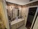 Bathroom with a tub, shower, toilet, mirror with lights, sink and vanity at 2033 Aaron Pl, Clearwater, FL 33760